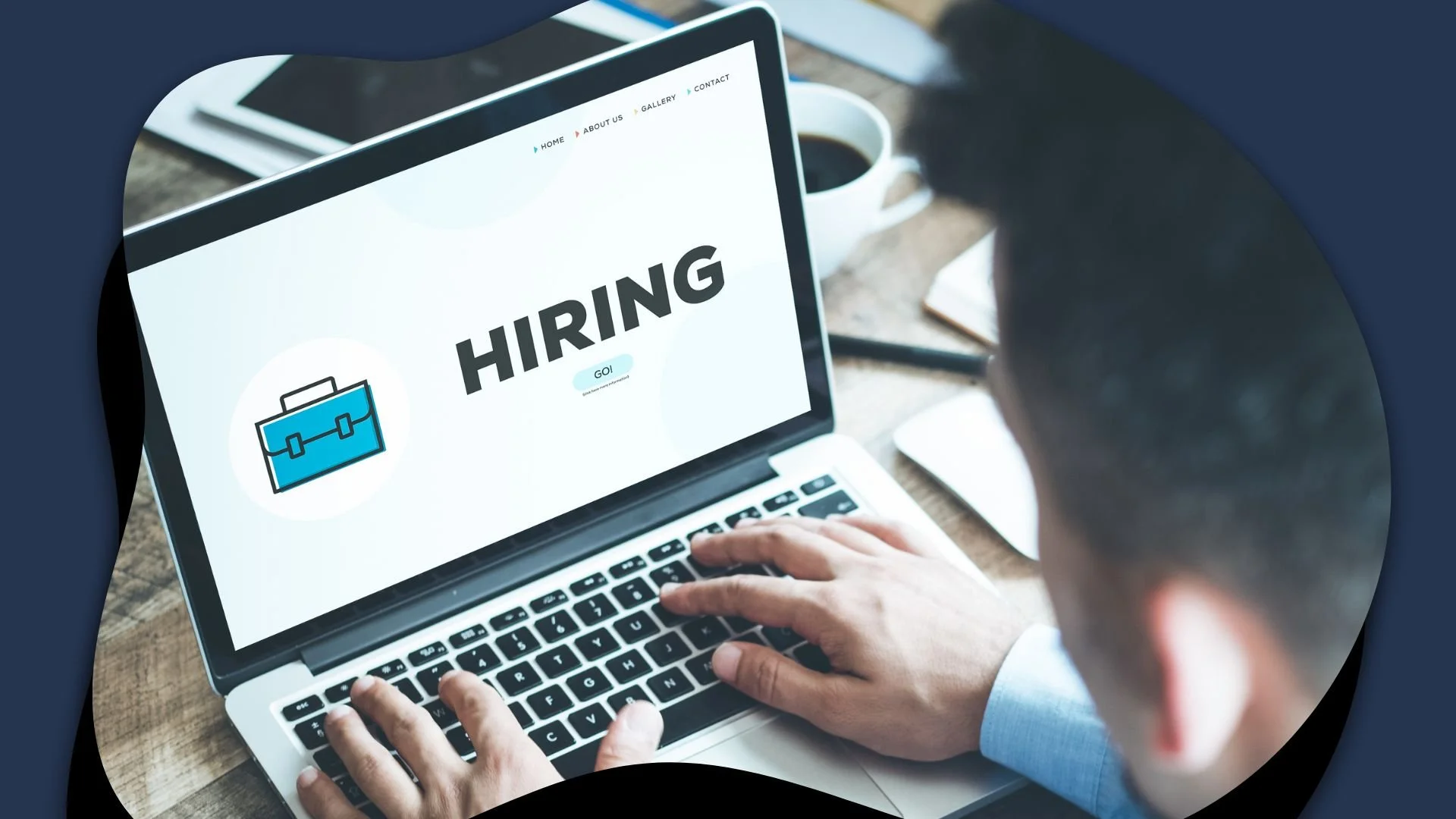 A person typing on a laptop with the word "HIRING" displayed on the screen.
